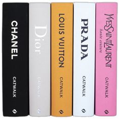 four books are lined up in a row on the same bookcase as one is black, white, and pink