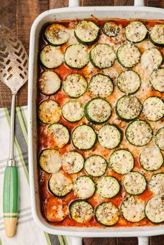 a casserole dish with zucchini and cheese