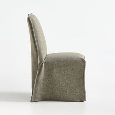 Our slipper-style dining chair is all dressed for dinner, donning a natural linen-blend slipcover that manages to look both casual and elegant. Skimming the armless hardwood frame and generously padded seat, the full-length slipcover has an informal, unconstructed air, minimally detailed with hand-sewn French seams in the front and along the back. We love the slipcovered dining chair's graceful silhouette and to-the-floor coverage.    Polyester-linen slipcover   Hardwood frame   Polyurethane foa White Slipcover, Slipcover Dining Chair, White Slipcovers, Linen Dining Chairs, Crate Barrel, Dining Chair Slipcovers, French Seam, Dinner Dress, Bespoke Furniture