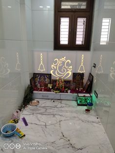 there is a white marble counter top in the room with many decorations on it and an open window