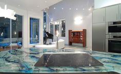 a modern kitchen with marble counter tops and stainless steel appliances in the backround