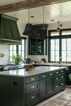 a kitchen with green cabinets and an island