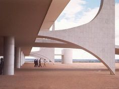 people are walking under an overpass in the desert