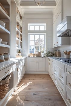 the kitchen is clean and ready for us to use it's white cabinetry