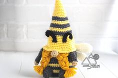 a crocheted bee wearing a yellow and black hat