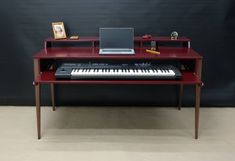 a laptop computer sitting on top of a red desk