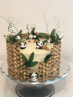 a cake decorated with bamboo and panda bears