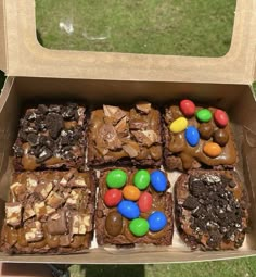 a box filled with brownies covered in candy