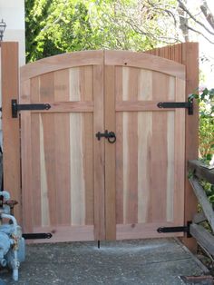 an open wooden gate with two black handles