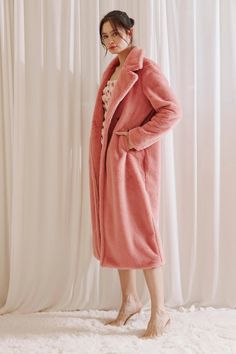 Stay warm and look fabulous this winter in the Athena Faux Fur Long Pink Coat. This mesmerizing coat features a notched collar, side pockets, and an open front with the option of buttoning up. You'll love the cozy warmth it provides without sacrificing any style! Stay chic and stay toasty! Material: Polyester Cozy Long Solid Color Outerwear, Cozy Long Outerwear With Pockets, Cozy Solid Color Open Front Outerwear, Cozy Open Front Solid Color Outerwear, Winter Solid Color Loungewear Outerwear, Long Winter Outerwear For Loungewear, Winter Loungewear Outerwear With Open Front, Soft Textured Winter Outerwear For Loungewear, Chic Outerwear With Soft Texture