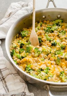 broccoli and macaroni casserole in a pan with a wooden spoon