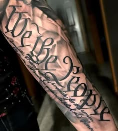 a man's arm with writing on it, and the words in black ink