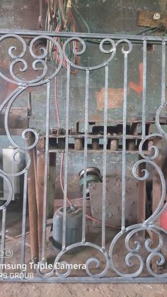 an old iron gate is in the middle of a room with other items on it