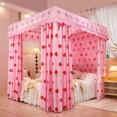 a pink canopy bed with curtains on the top and bottom, sitting in a room