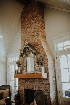 a brick fireplace with a mirror above it