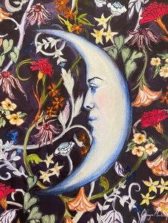 a painting of a woman's face on the moon with flowers and vines around it