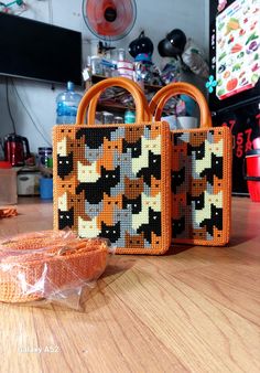 two purses sitting on top of a wooden table