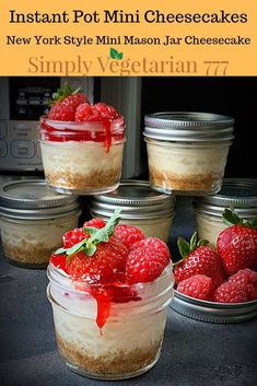 four mason jars filled with cheesecake and raspberries