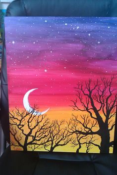 an acrylic painting of the moon and tree silhouettes against a colorful sky