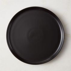 a black plate sitting on top of a white counter