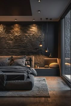 a large bed sitting next to a window in a room with dark walls and wooden floors