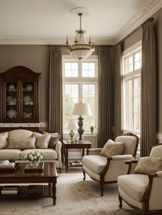 a living room filled with furniture and a chandelier