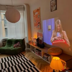 a living room filled with furniture and a flat screen tv mounted to the side of a wall