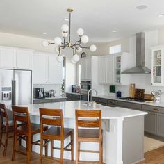 a large kitchen with an island in the middle