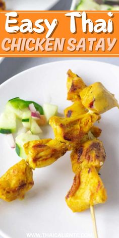 chicken satay on a white plate with cucumbers