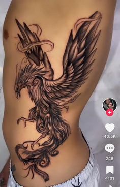 an image of a tattoo on the side of a woman's stomach with a bird