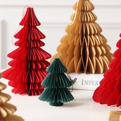 paper christmas trees are lined up on a table