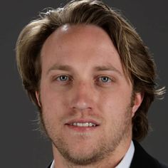 a man in a suit and tie looking at the camera