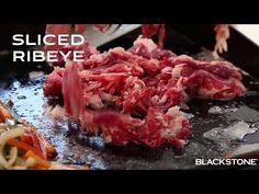 raw meat being cooked in a skillet with the words sliced ribeye on it