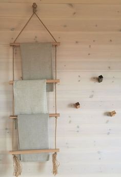 two towels are hanging on a wooden rack