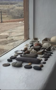 rocks and stones are arranged on the window sill