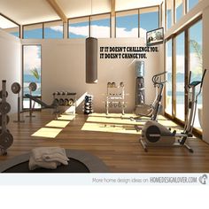 there are many exercise equipment in the room with large windows that look out onto the ocean