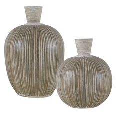 two large vases sitting next to each other on a white surface with lines drawn across them