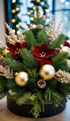 a christmas arrangement with poinsettis and greenery