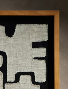 a black and white framed artwork with the letter f in it's lower half