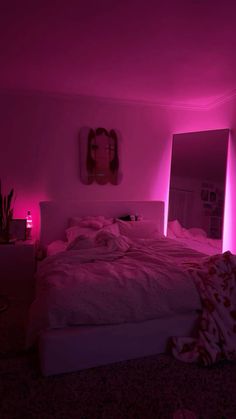 a bed in a room with pink lighting