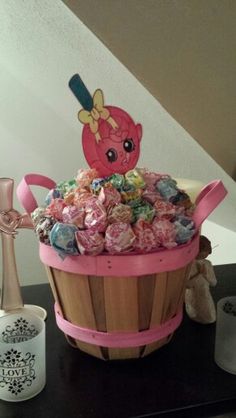 a basket filled with lots of candy sitting on top of a table