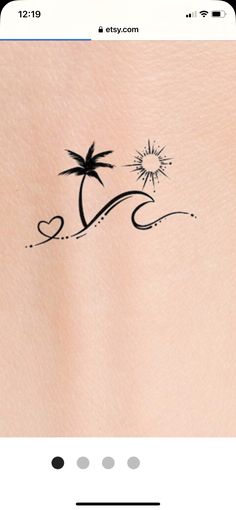 the back of a woman's stomach with a small palm tree tattoo on it