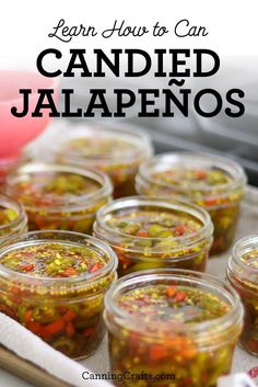 several jars filled with pickled jalapenos sitting on top of a table