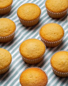 several muffins sitting on top of a blue and white striped table cloth next to each other