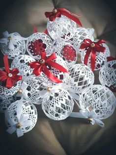 some white balls with red bows on them