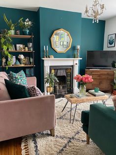 a living room filled with furniture and a fire place next to a wall mounted tv