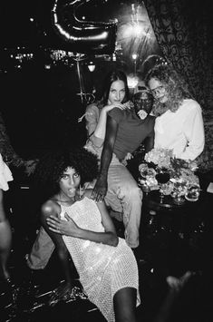 black and white photograph of four women in a club