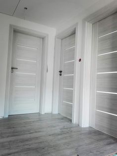 two white doors are open in an empty room