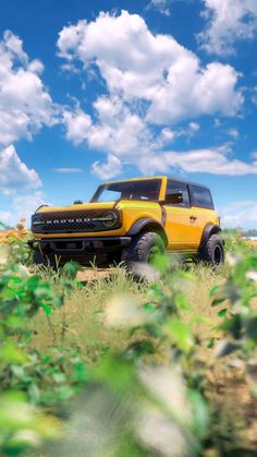 yellow Ford Bronco model car stationary with a beautiful skyscape in the background and flowers on the ground Ford Bronco Wallpaper Iphone, Ford Bronco Wallpaper, Bronco Wallpaper, Car Party Theme, Horizon Wallpaper, Broncos Wallpaper, Bronco Ford