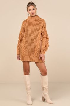 Winter's warmest must-have is hereâ€”the Lulus Coziest Heart Tan Oversized Cable Knit Fringe Sweater Mini Dress! This essential dress is composed of ultra-chunky knit that shapes a ribbed knit turtleneck and a relaxed-fit bodice with cabled details throughout. Boho-chic fringe trim runs across the dropped shoulders and down the outside edges of the long sleeves, ending at ribbed cuffs. Ribbed knit mini hem completes the look. Fit: This garment fits true to size. Length: Mid-thigh. Size medium measures 29.5" from shoulder to hem. Bust: Great for any cup size. Waist: Not Fitted - comfortable room throughout midsection. Hip: Not Fitted - room for hips. Undergarments: May be worn with any standard bra. Fabric: Fabric is very stretchy. Unlined. 100% Acrylic. Hand Wash Cold. Do Not Bleach. Hang Brown Knit Sweater Dress For Winter, Cozy Cable Knit Dresses For Fall, Cozy Knitted Sweater Dress For Fall, Brown Knitted Sweater Dress For Winter, Fall Cable Knit Sweater Dress, Knitted Sweater Dress For Fall, Cozy Brown Sweater Dress For Winter, Cozy Brown Winter Sweater Dress, Oversized Brown Dress For Winter